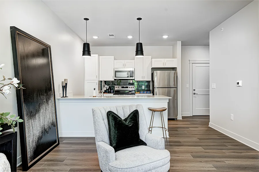 An apartment living room and kitchen at East Bank Noblesville Riverside Apartments