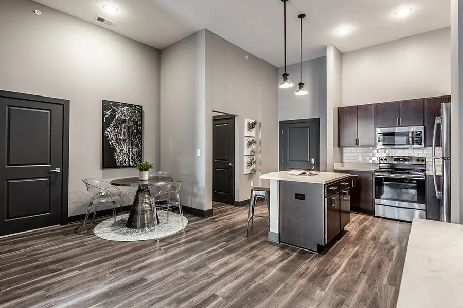 Keep emergency supplies in a cabinet or closet like these at Spark Apartments. A contemporary apartment kitchen, dining room, and entryway