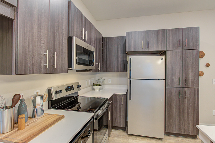 Modern kitchen with neutral colors, located at Penrose Apartments.